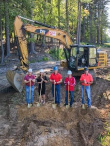 Holtz Management Team digging iin dirt with a bulldozer