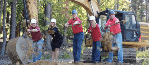 Holtz Builders Management Team throwing dirt
