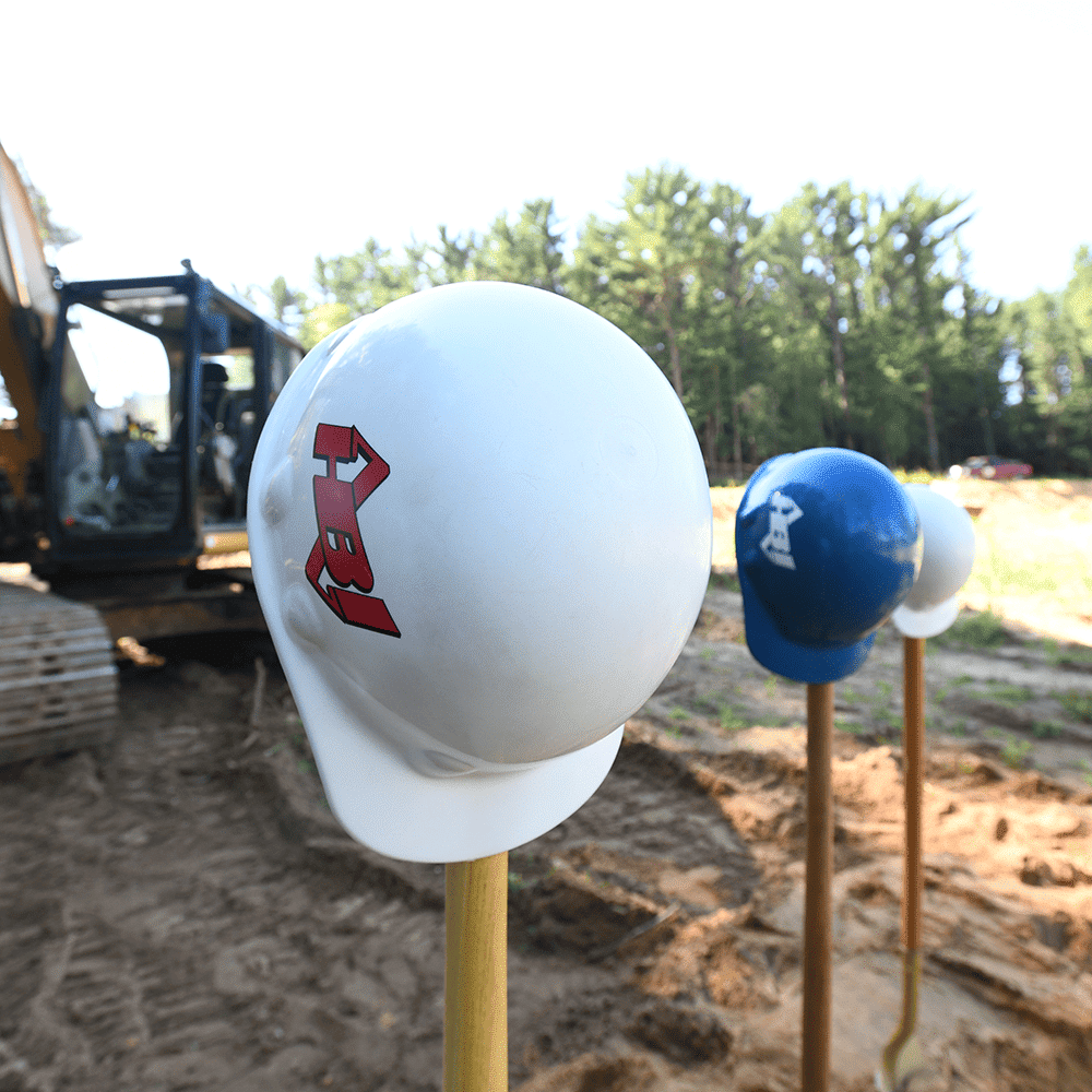 Holtz Builders - helmets on poles at a work site<br />
